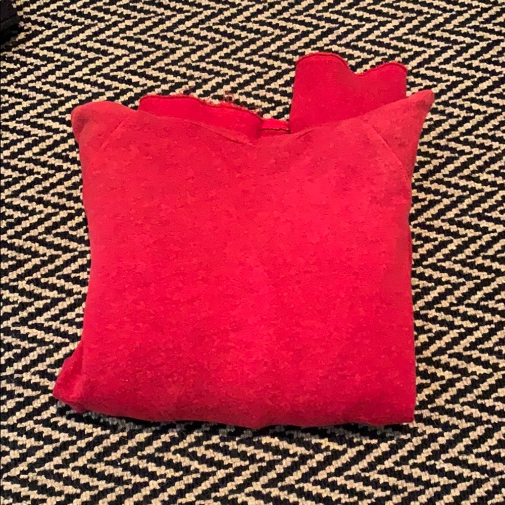 A red hoodie from the brand Sundry
